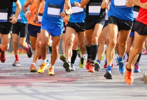 men's and women's legs while running marathon in the city